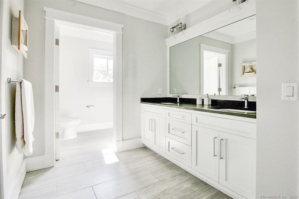 17 Stony Brook Road Westport, CT 06880 - Photo 22 of 39 a bathroom with a double vanity sink and mirror