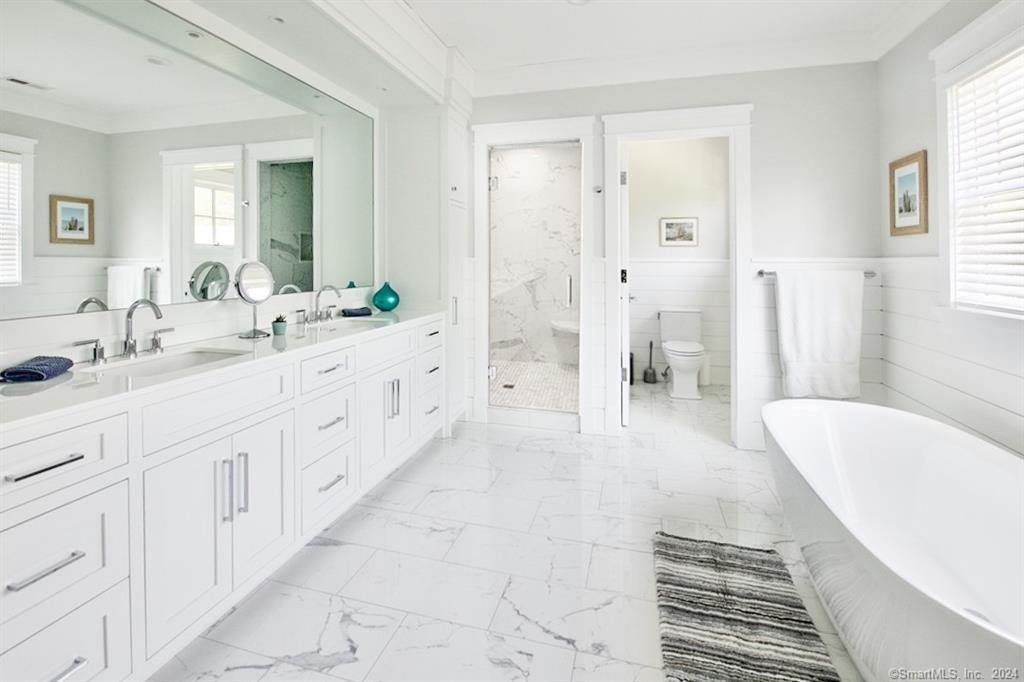 17 Stony Brook Road Westport, CT 06880 - Photo 24 of 39 a spacious en suite bathroom with a double vanity sink a large mirror and a shower