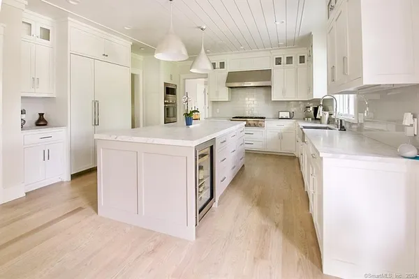 a large white kitchen with cabinets