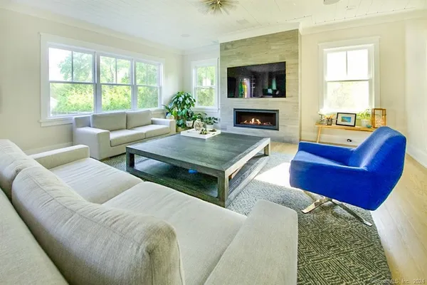 a dining room with furniture a window and a fireplace
