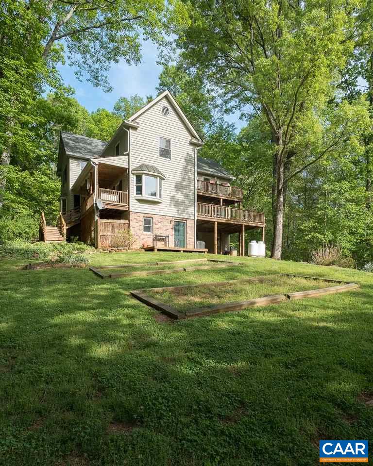 5990 Buck Ridge Road Earlysville, VA 22936 - Photo 17 of 18 a front view of a house with garden