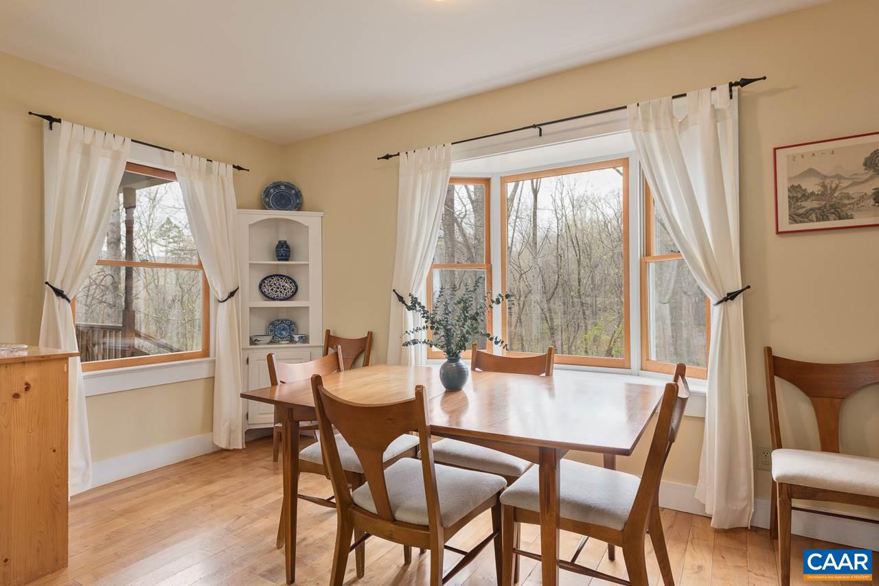 5990 Buck Ridge Road Earlysville, VA 22936 - Photo 5 of 18 a dining room with furniture a chandelier and wooden floor