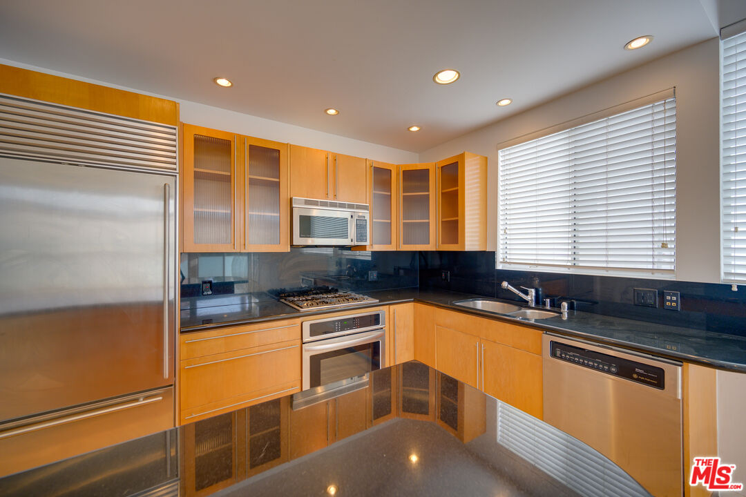 14 Privateer Street, Unit 1 Marina del Rey, CA 90292 - Photo 11 of 32 a kitchen with granite countertop a sink and a stove top oven
