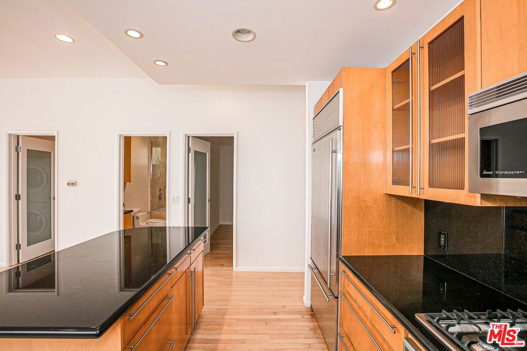 14 Privateer Street, Unit 1 Marina del Rey, CA 90292 - Photo 14 of 32 a kitchen with stainless steel appliances granite countertop a refrigerator and a stove top oven