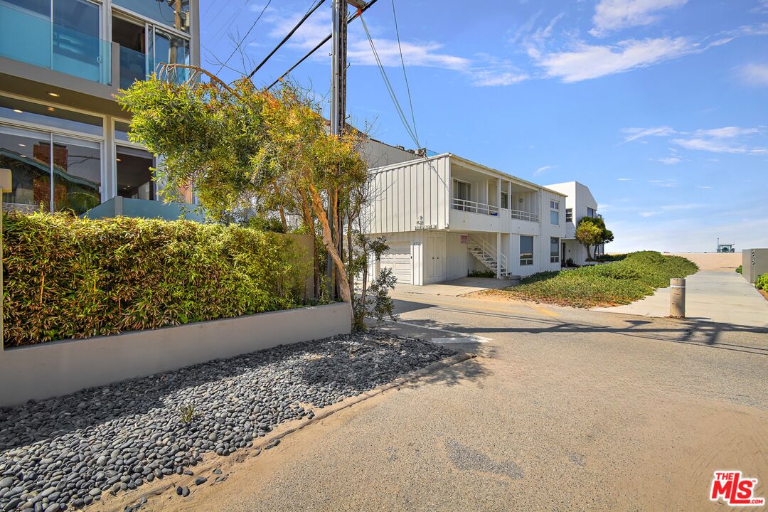 14 Privateer Street, Unit 1 Marina del Rey, CA 90292 - Photo 27 of 32 a front view of a house with a yard