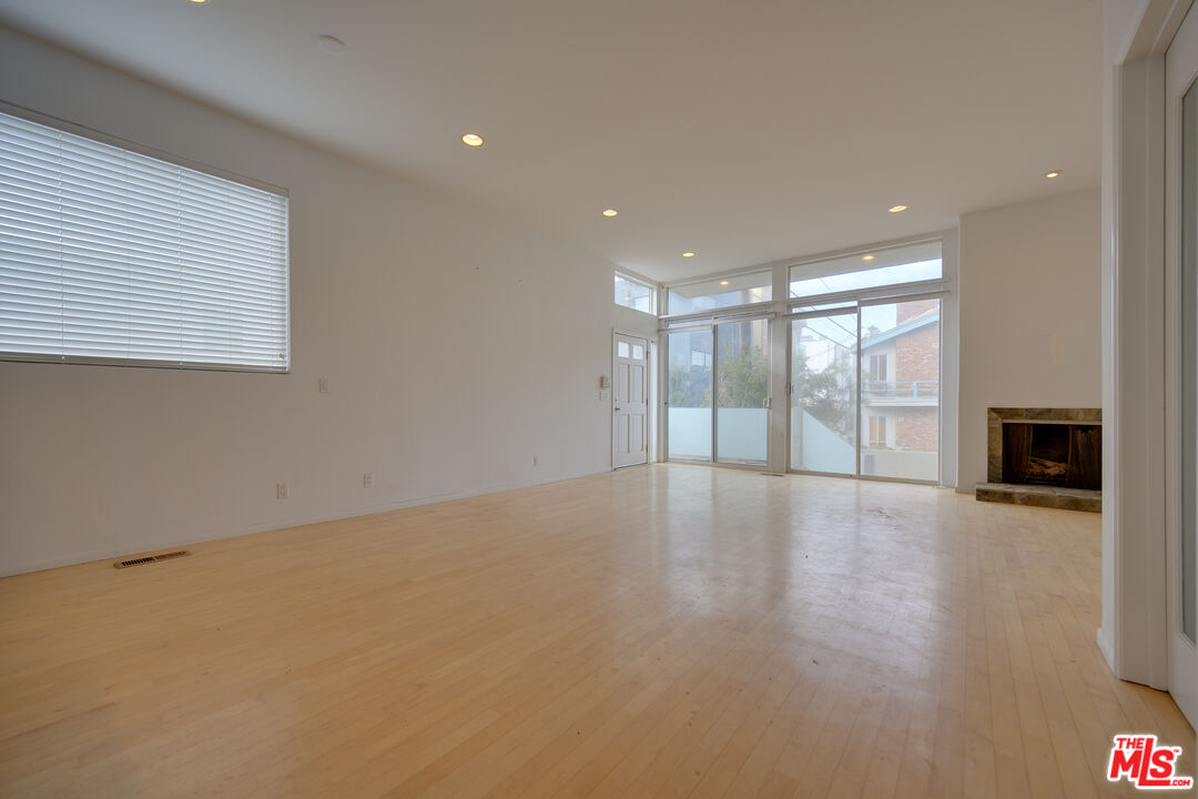 14 Privateer Street, Unit 1 Marina del Rey, CA 90292 - Photo 6 of 32 a view of an empty room with a window and wooden floor