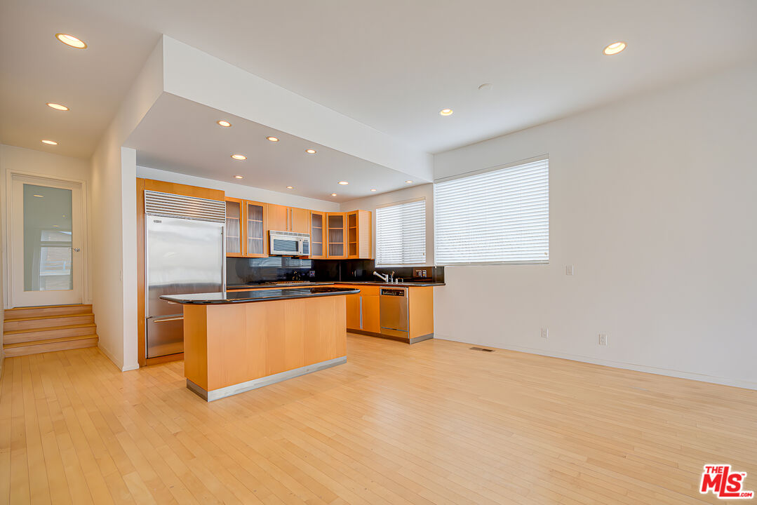 14 Privateer Street, Unit 1 Marina del Rey, CA 90292 - Photo 8 of 32 a large kitchen with stainless steel appliances a large counter top and a stove