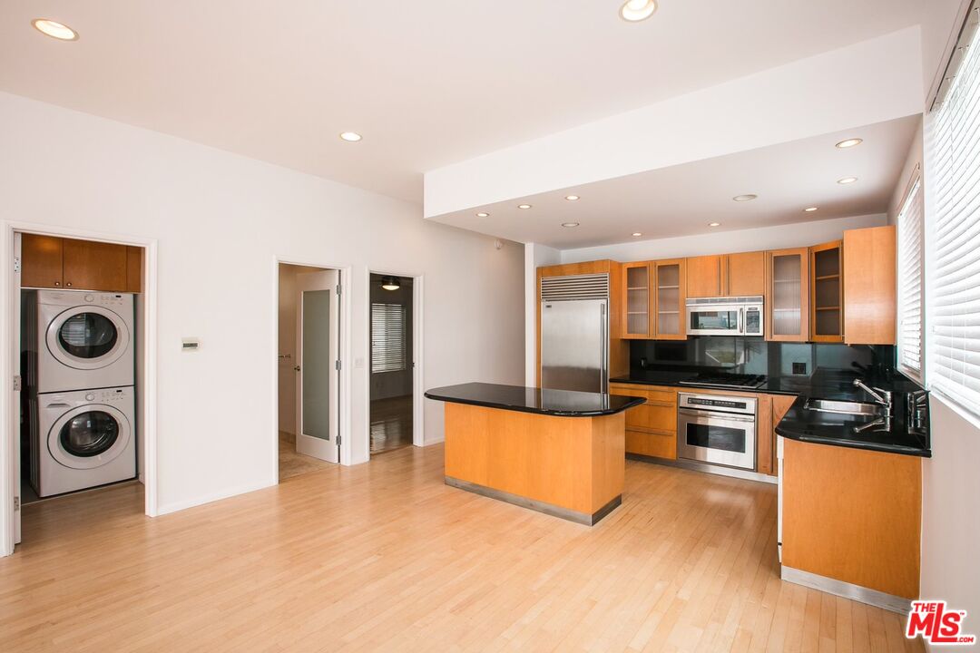 14 Privateer Street, Unit 1 Marina del Rey, CA 90292 - Photo 9 of 32 a kitchen with stainless steel appliances granite countertop a stove and a refrigerator