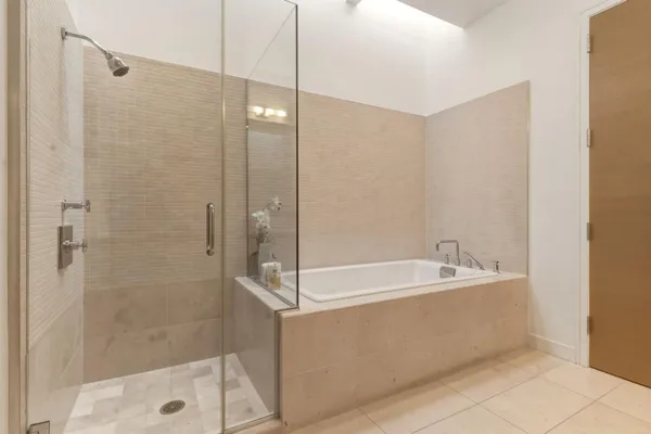 a spacious bathroom with a bathtub and a shower