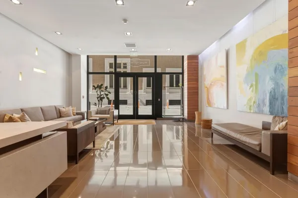 a living room with furniture and large windows