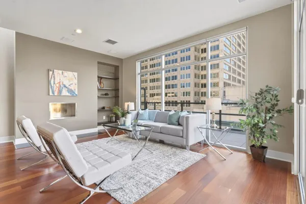 a living room with furniture and a potted plant