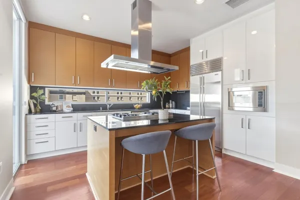 a kitchen with a table chairs stove and cabinets