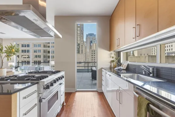 a kitchen with stainless steel appliances granite countertop a sink stove and refrigerator