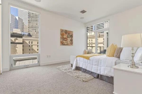 a spacious bedroom with a bed and a cabinets