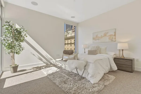 a bedroom with a bed and a window