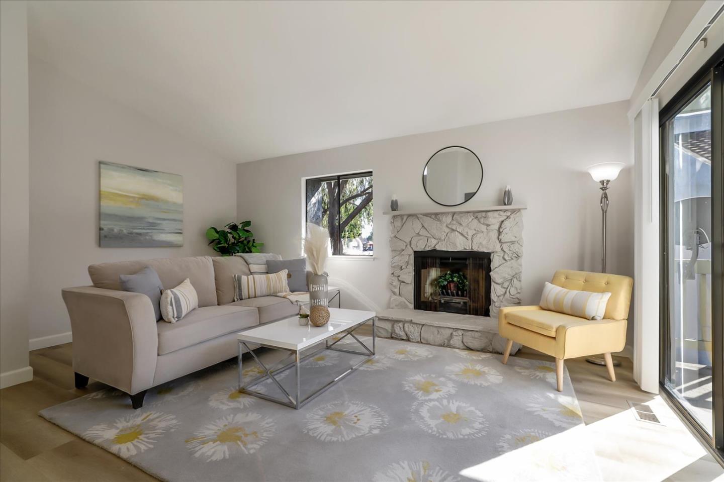 1239 Henderson Avenue, Unit R Sunnyvale, CA 94086 - Photo 12 of 42 a living room with furniture a fireplace and a large window