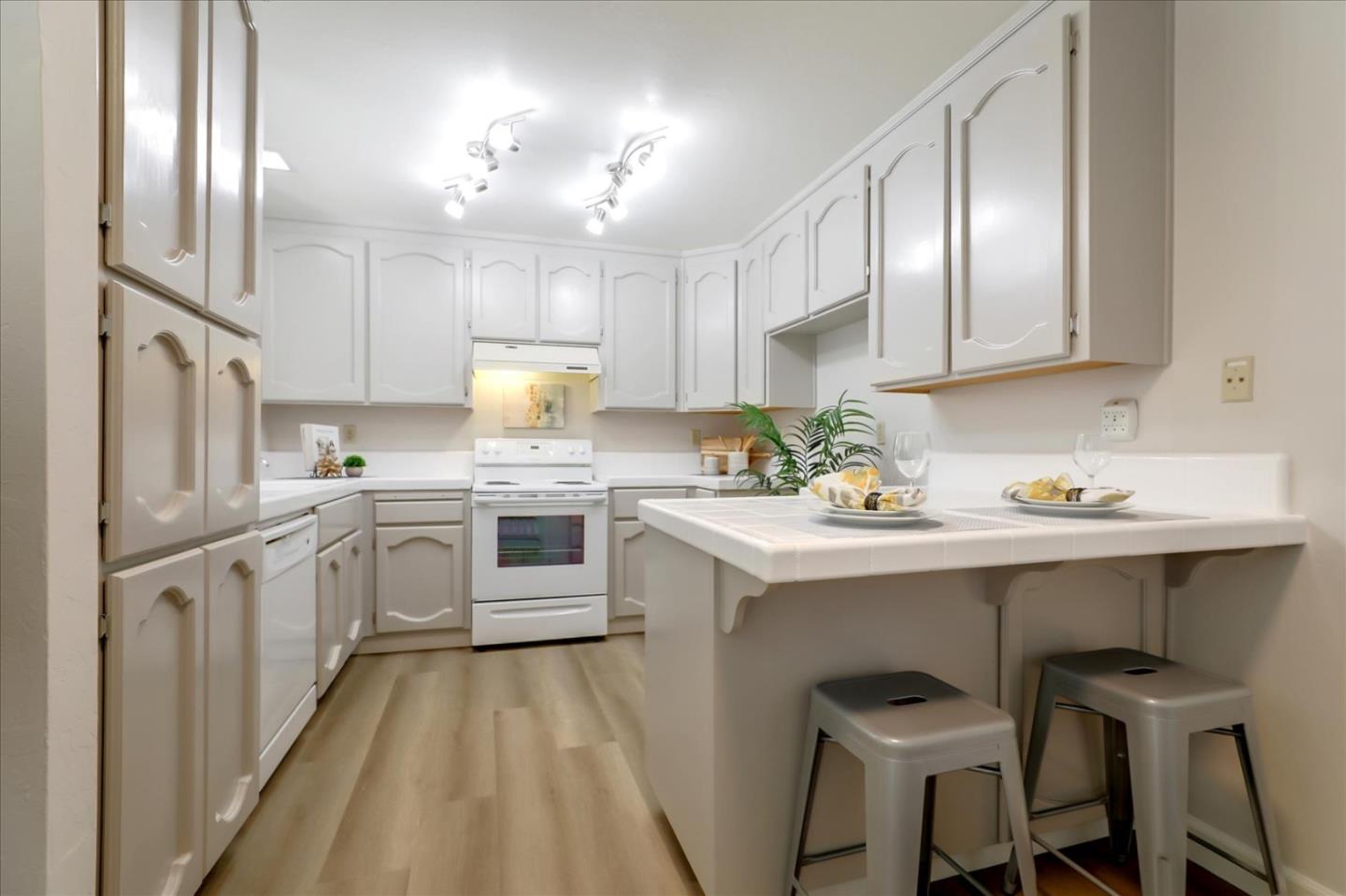 1239 Henderson Avenue, Unit R Sunnyvale, CA 94086 - Photo 15 of 42 a kitchen with a sink refrigerator and cabinets