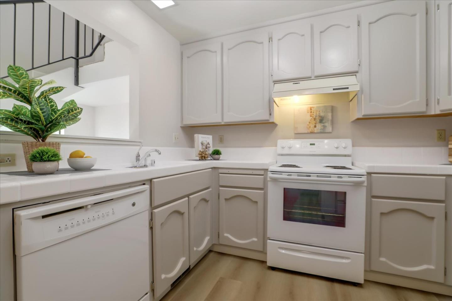 1239 Henderson Avenue, Unit R Sunnyvale, CA 94086 - Photo 16 of 42 a kitchen with white cabinets and white appliances