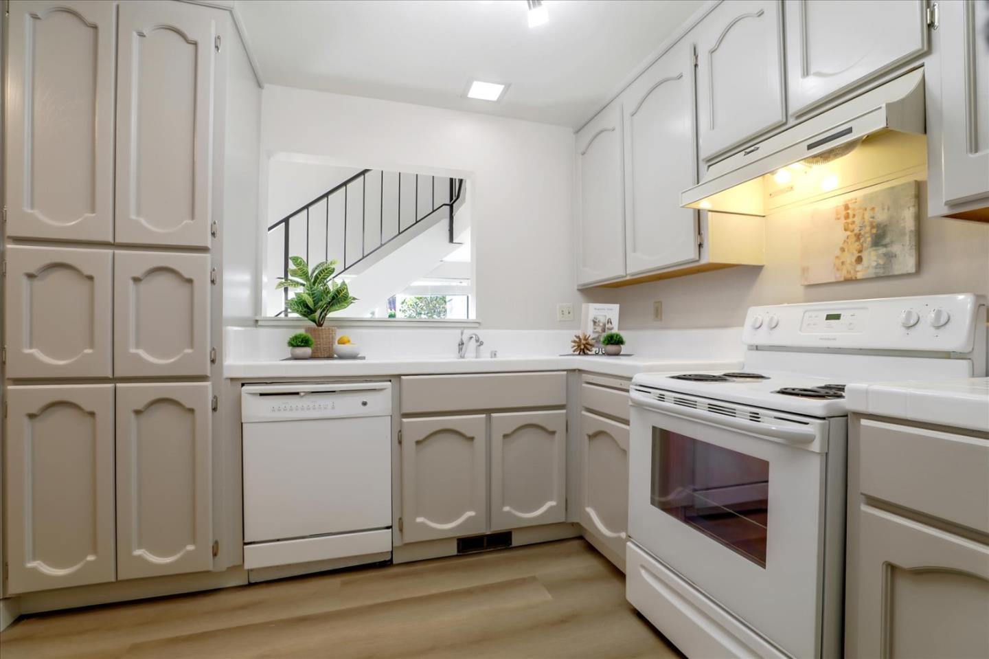 1239 Henderson Avenue, Unit R Sunnyvale, CA 94086 - Photo 17 of 42 a kitchen with white cabinets and white appliances