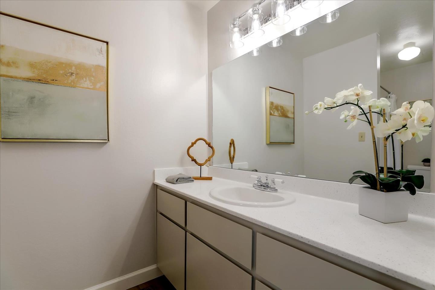 1239 Henderson Avenue, Unit R Sunnyvale, CA 94086 - Photo 24 of 42 a bathroom with a sink a vanity and a mirror