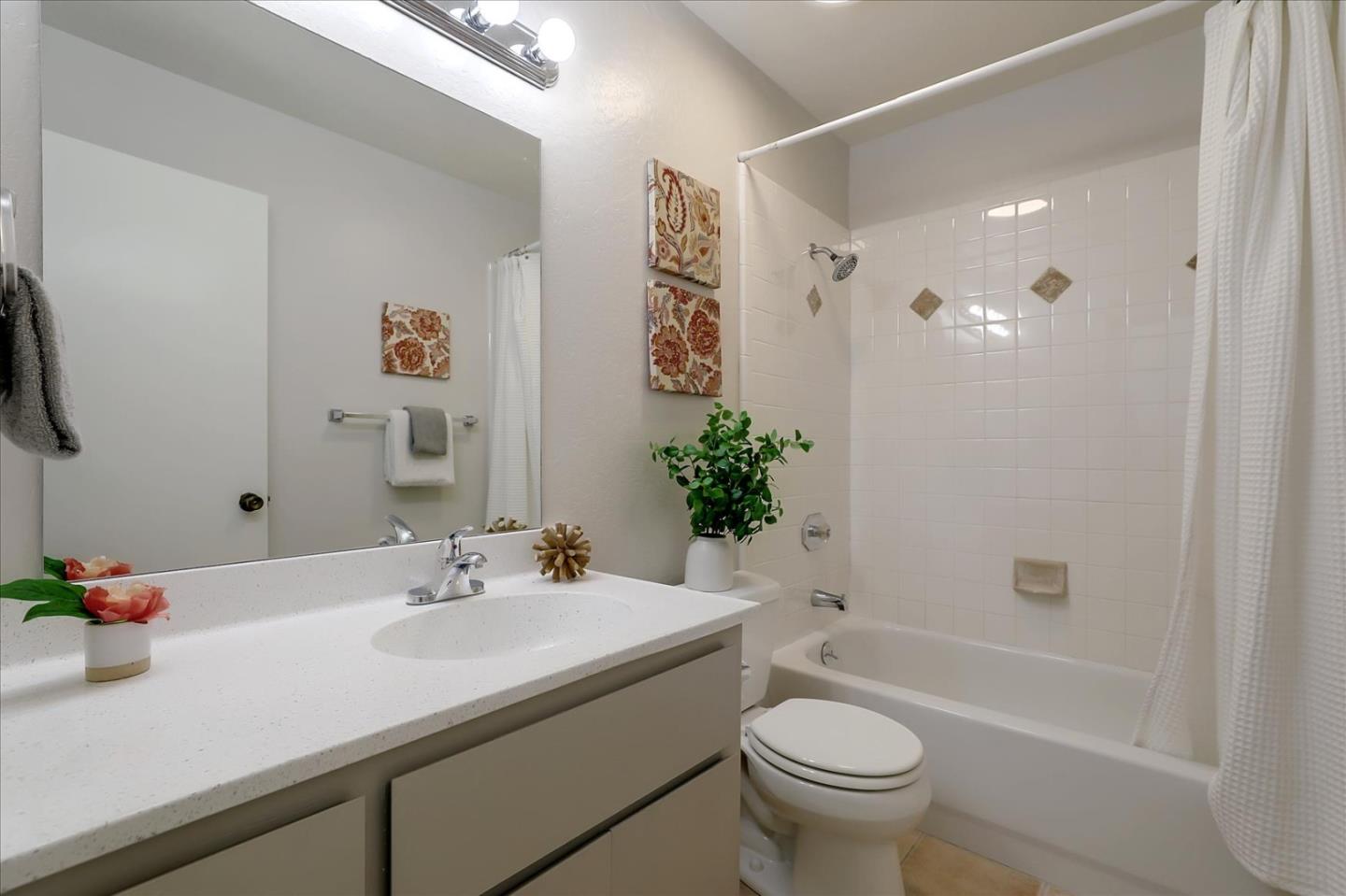 1239 Henderson Avenue, Unit R Sunnyvale, CA 94086 - Photo 35 of 42 a bathroom with a granite countertop sink a toilet and shower
