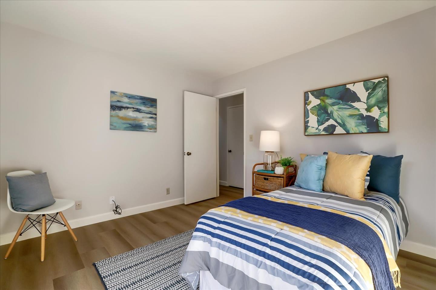 1239 Henderson Avenue, Unit R Sunnyvale, CA 94086 - Photo 38 of 42 a bedroom with a bed and a painting on the wall