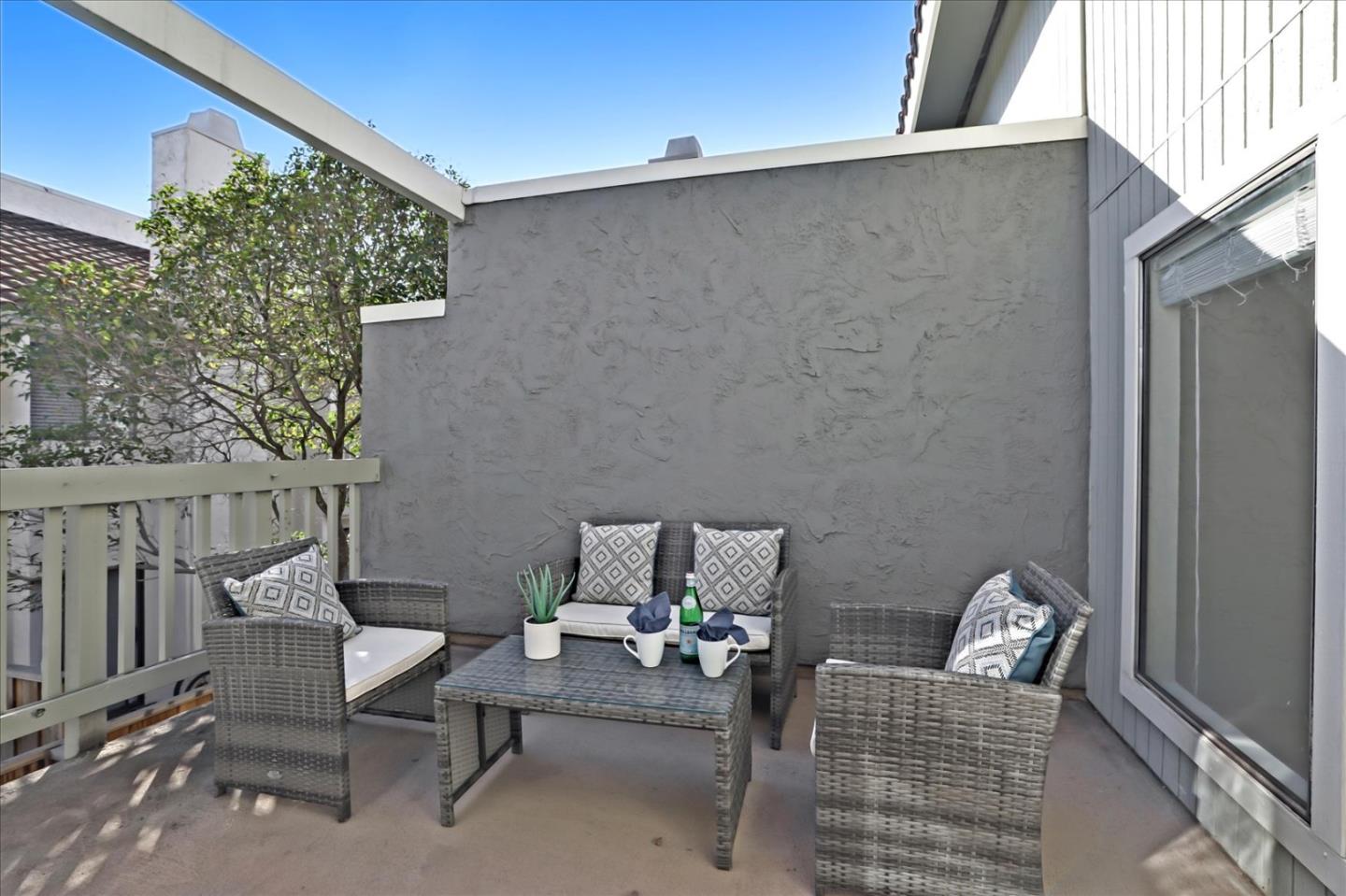 1239 Henderson Avenue, Unit R Sunnyvale, CA 94086 - Photo 9 of 42 a balcony with couple of chairs and a wall