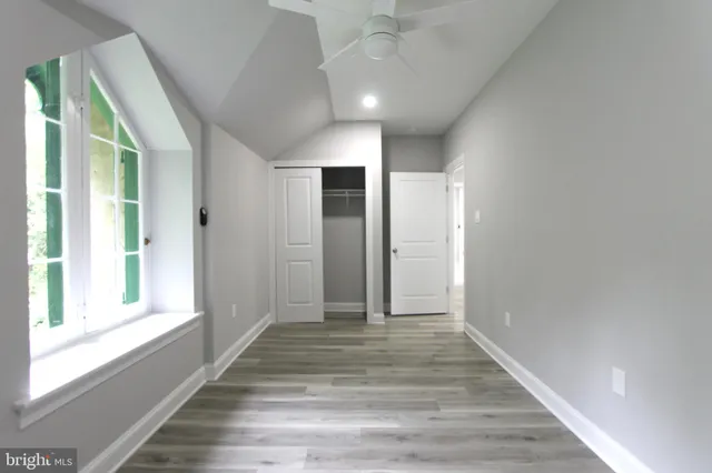 a view of a room with wooden floor and windows