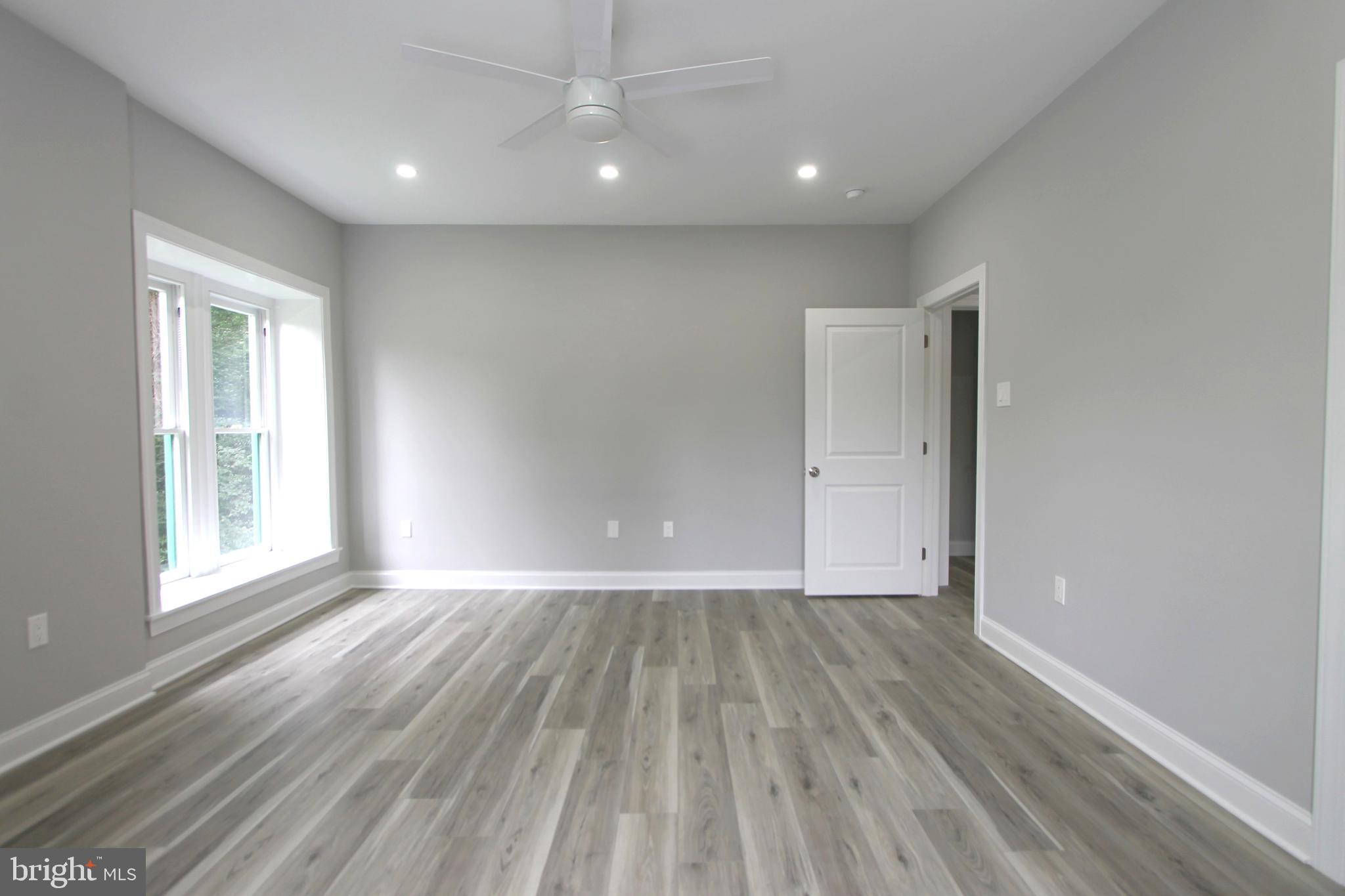 5925-31 Devon Place Philadelphia, PA 19138 - Photo 16 of 27 an empty room with wooden floor and windows