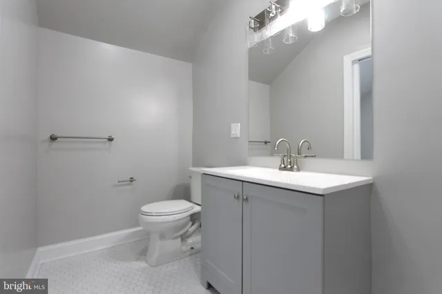a bathroom with a sink a toilet and a mirror