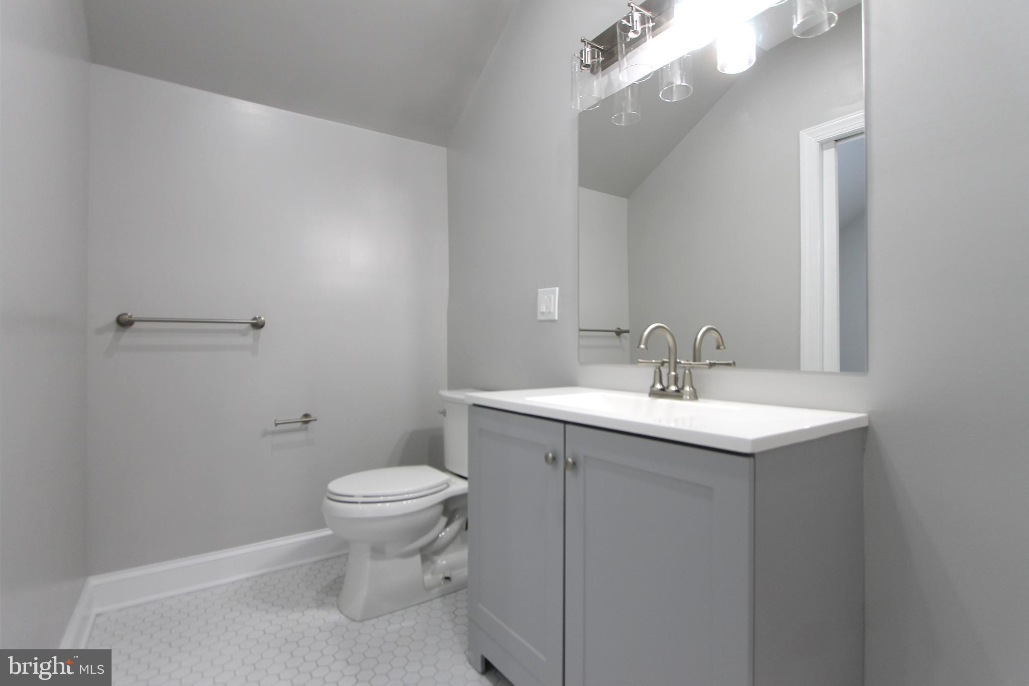 5925-31 Devon Place Philadelphia, PA 19138 - Photo 23 of 27 a bathroom with a sink a toilet and a mirror