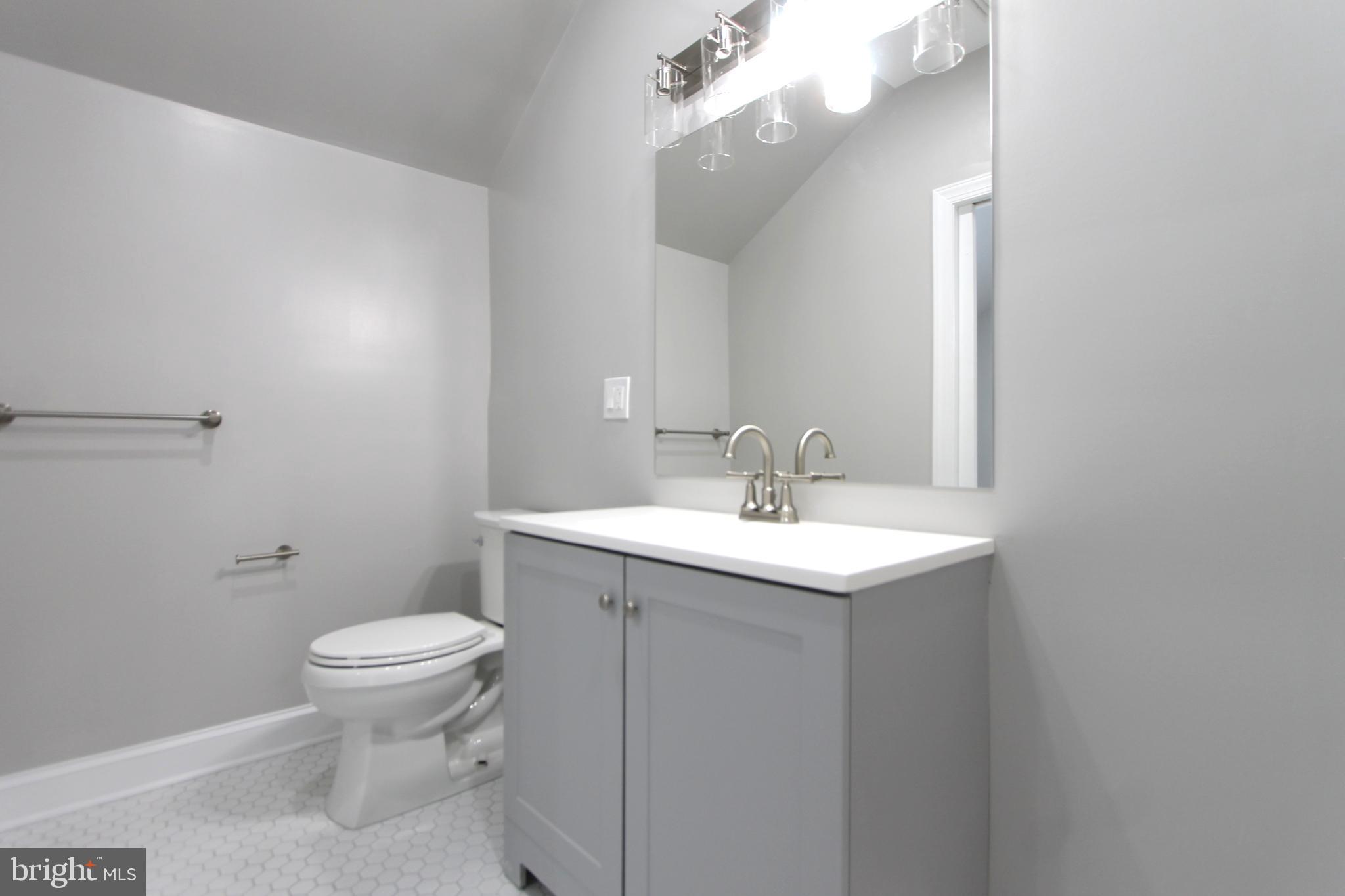 5925-31 Devon Place Philadelphia, PA 19138 - Photo 24 of 27 a bathroom with a toilet a sink and mirror
