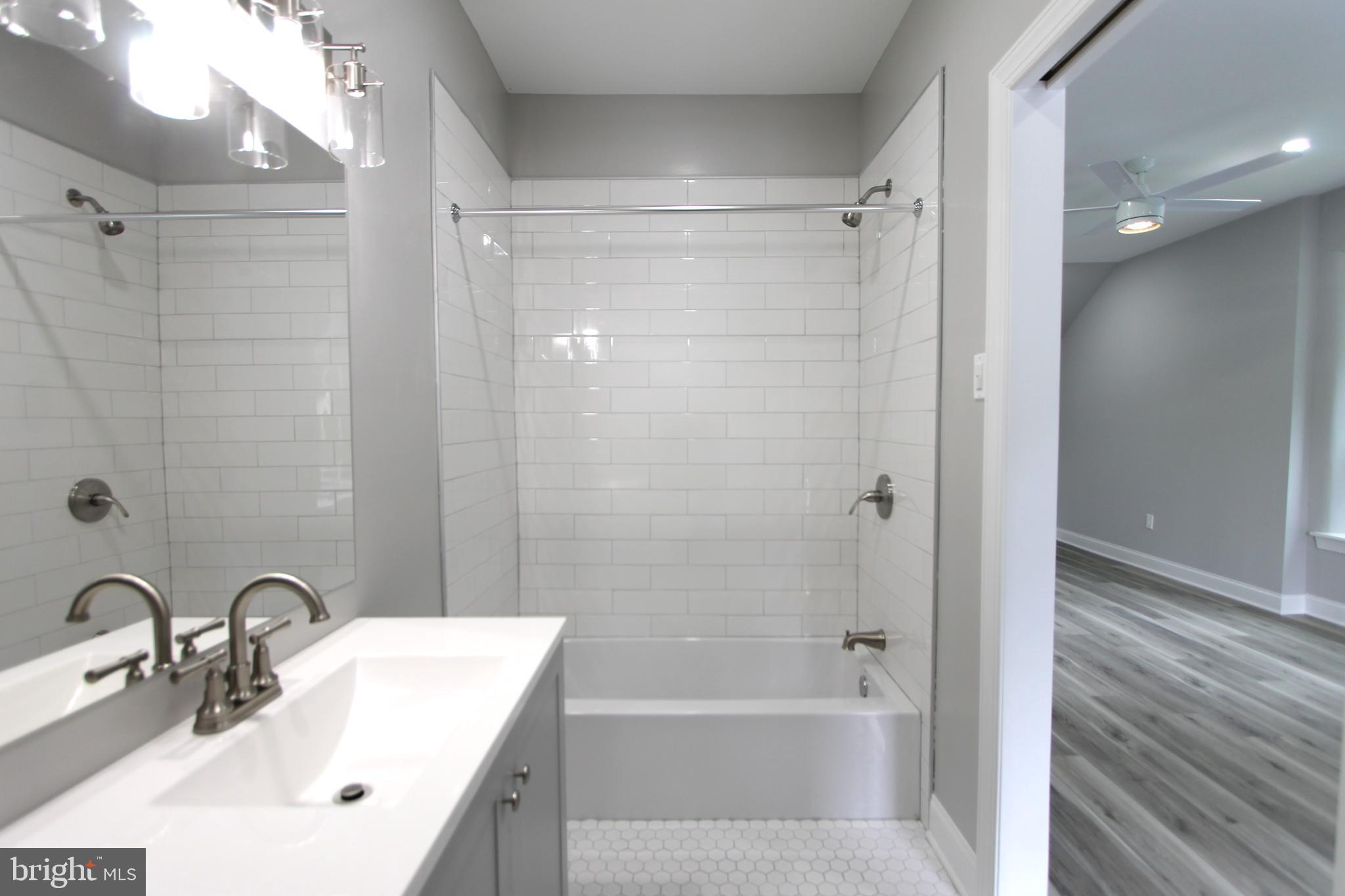 5925-31 Devon Place Philadelphia, PA 19138 - Photo 25 of 27 a bathroom with a bathtub shower sink vanity and a toilet
