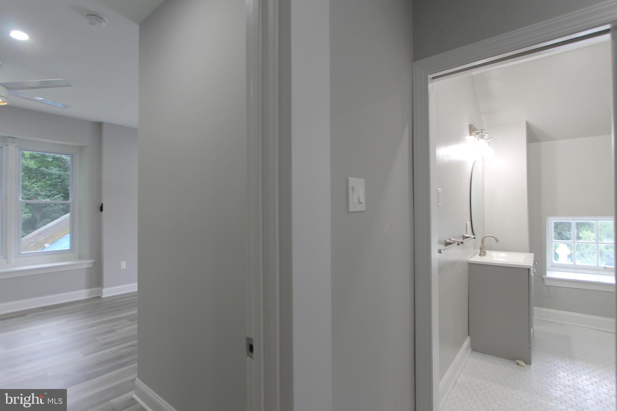 5925-31 Devon Place Philadelphia, PA 19138 - Photo 26 of 27 a view of a hallway with wooden floor and a bathroom