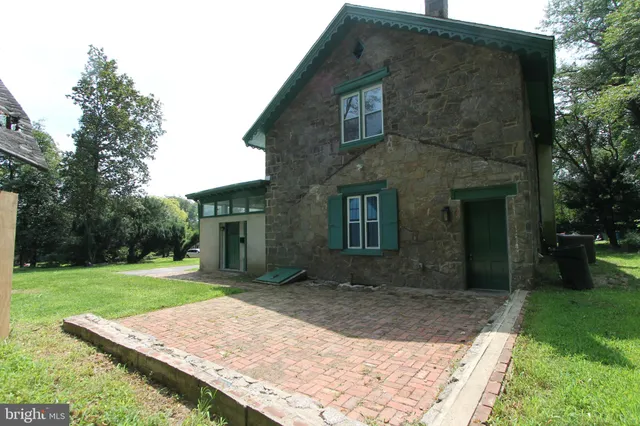 a view of a brick house with a yard