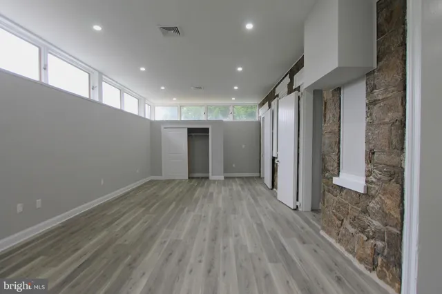 a view of a hallway with wooden floor