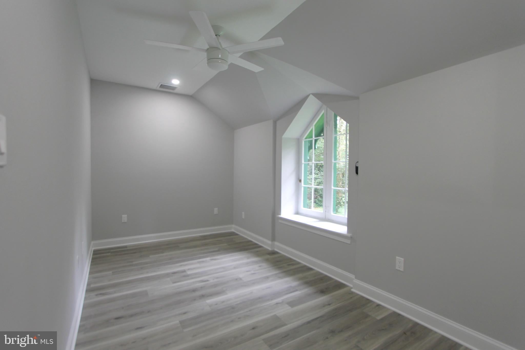 5925-31 Devon Place Philadelphia, PA 19138 - Photo 9 of 27 an empty room with wooden floor and windows