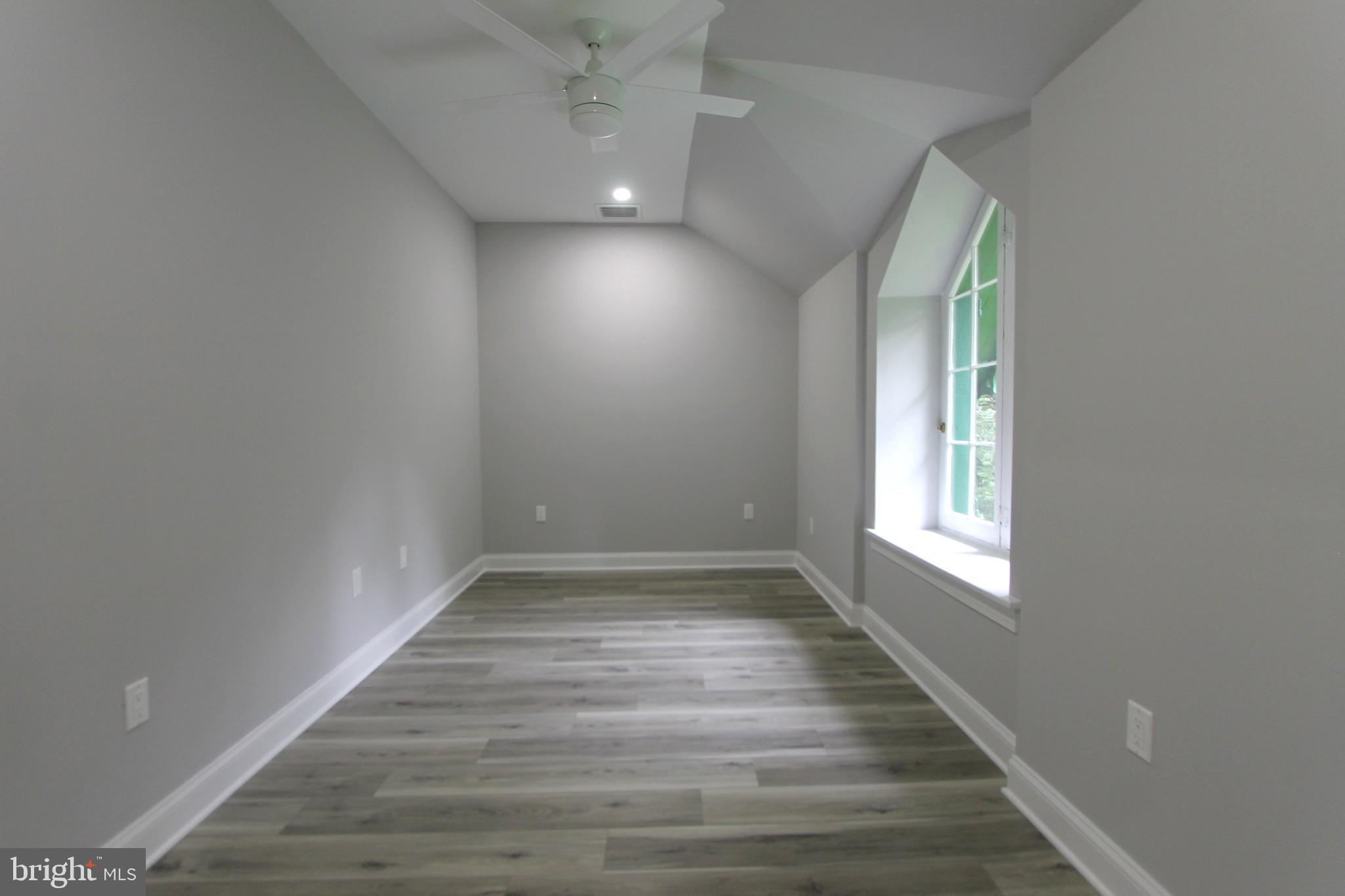 5925-31 Devon Place Philadelphia, PA 19138 - Photo 10 of 27 an empty room with wooden floor and windows