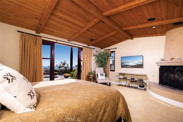 a bed room with a bed and a tv