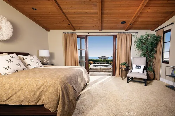 a bed room with a bed and a chair
