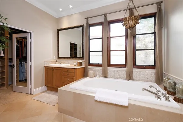 a large bedroom with a large bed and a window