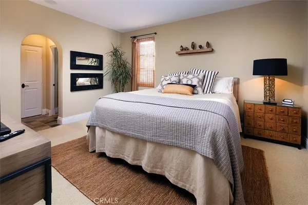 a bedroom with a bed and a night stand