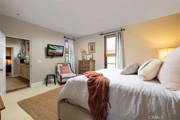 a bedroom with a bed wooden floor and furniture