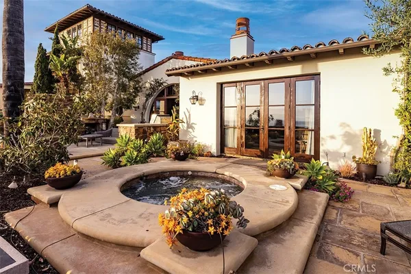 a view of a house with backyard swimming pool and sitting area