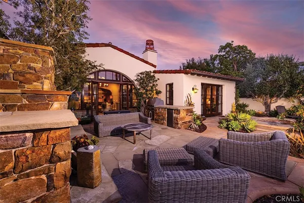 a view of a patio with couches table and chairs and potted plants