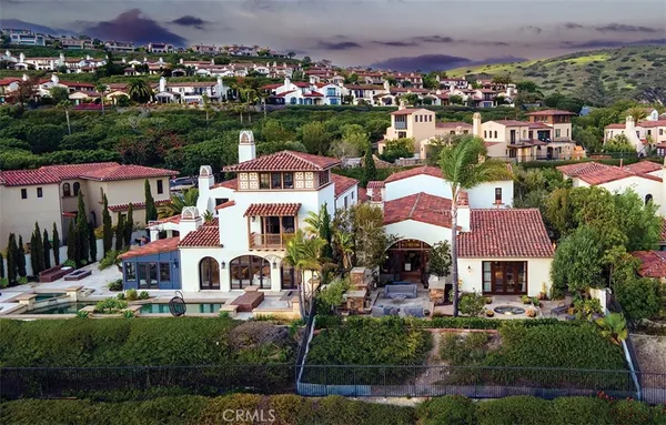 a aerial view of a houses with a yard and outdoor seating