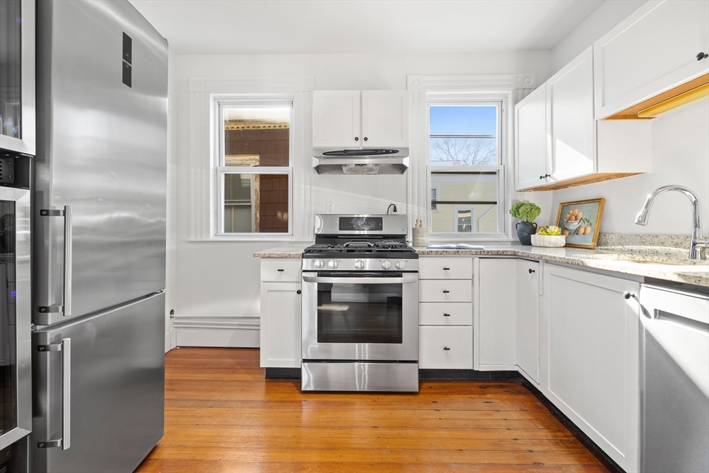 112 Franklin Street, Unit 3 Brookline, MA 02445 - Photo 4 of 16 a kitchen with a stove and a refrigerator