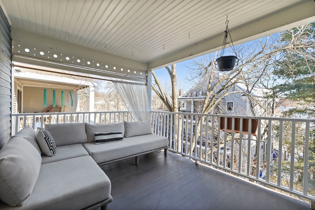 112 Franklin Street, Unit 3 Brookline, MA 02445 - Photo 7 of 16 a balcony with furniture and a large window