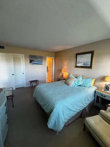 a bed sitting in a bedroom next to a lamp