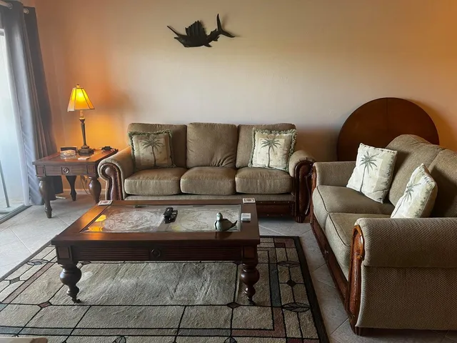 a living room with a couch and a rug